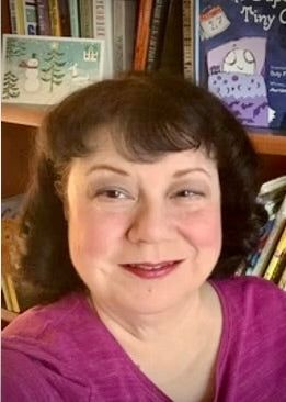 Marilee Joy Mayfield at her bookshelf